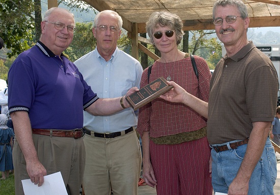 Haywood Community College's Professional Crafts Program received the 2005 Mountain Heritage Award during festivities at Western's 31st annual Mountain Heritage Day on Saturday, Sept. 24. HCC representatives (right to left) Gary Clontz, chair of the department of professional crafts; Catherine Ellis, fiber arts instructor; and Bill Rhodarmer, assistant vice president for academic services; accept the award from Clifton Metcalf, Western's vice chancellor for advancement and external affairs.