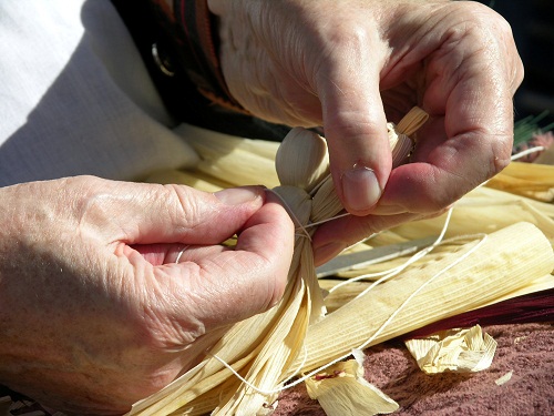 Annie Lee Bryson working on a traditional corn husk doll.